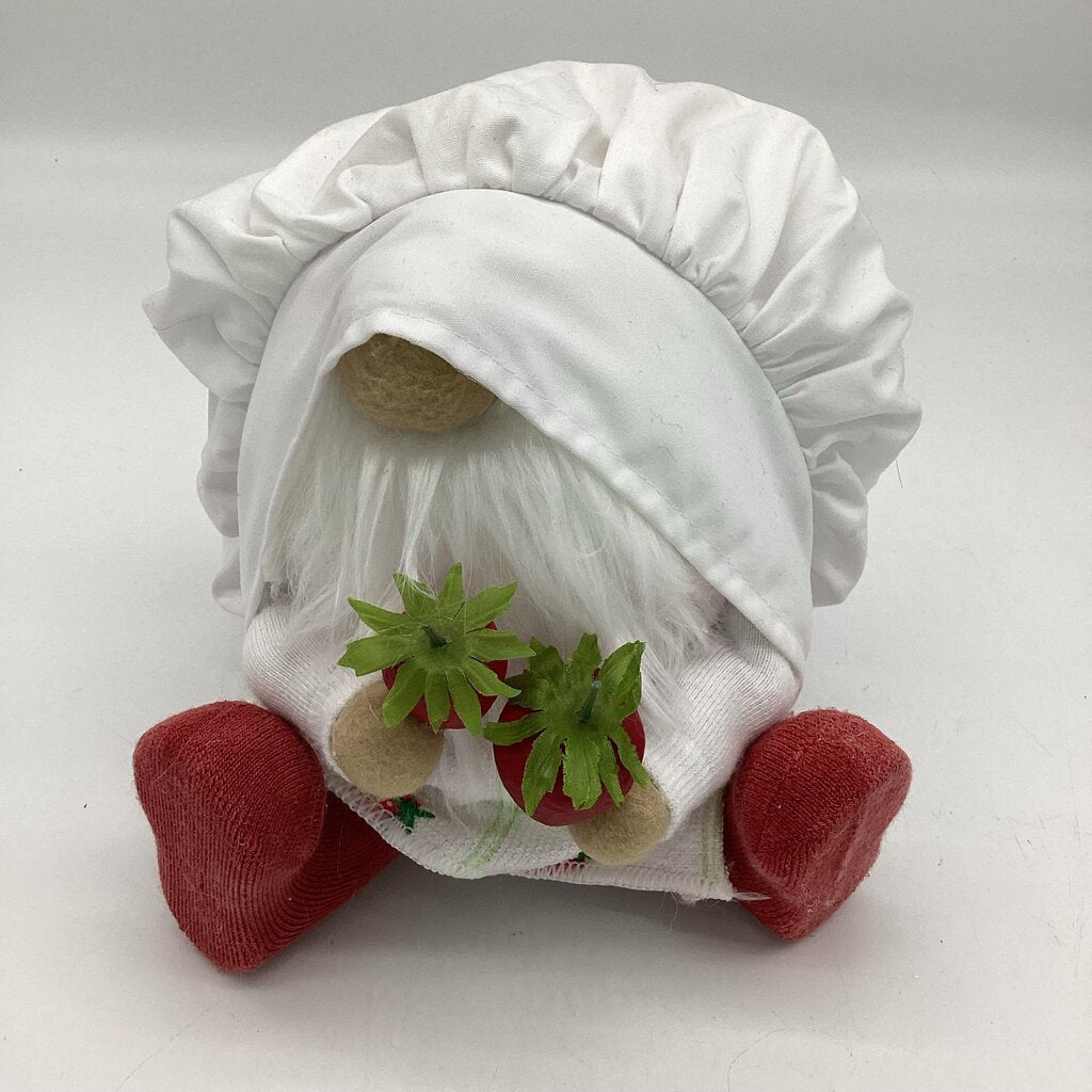 small chef gnome eating strawberries