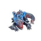 black body, red snout and blue ears/horns and fins