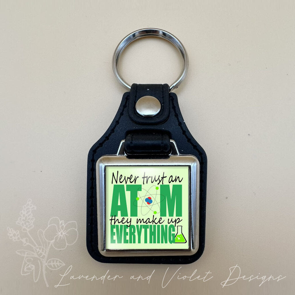 NEVER TRUST AN ATOM VINYL KEYCHAIN SQUARE