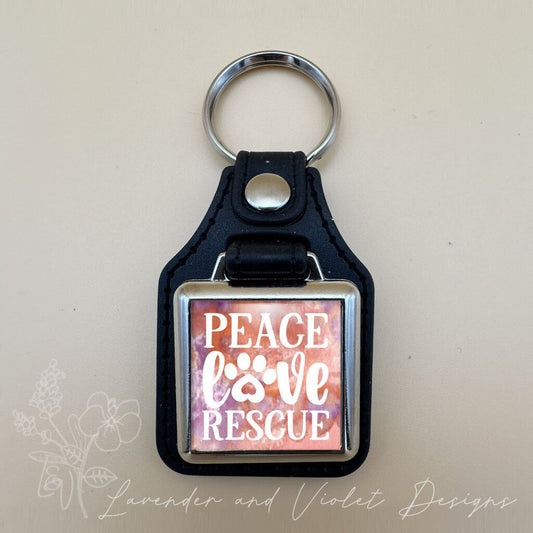 PEACE LOVE RESCUE VINYL KEYCHAIN SQUARE