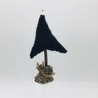 black tree with beige and black homespun fabric and silver tone bead topper