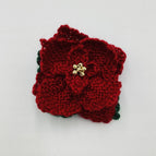 Ruby petals with dark green leaves and gold tone beaded center