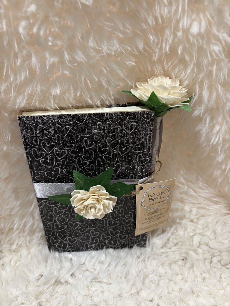 Notebook w/ pen featuring a soft close magnet in black with white hearts, white flowers with gray ribbon