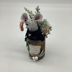 grey mouse in rusty can with white berries