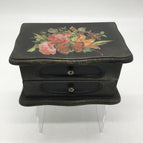 Black with gold details, and red floral transfers