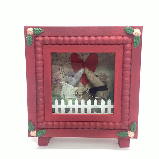 mouse couple kissing in red diorama box