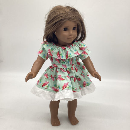 Light green dress with mushrooms all over. Ruffles around neckline and bottom skirt.