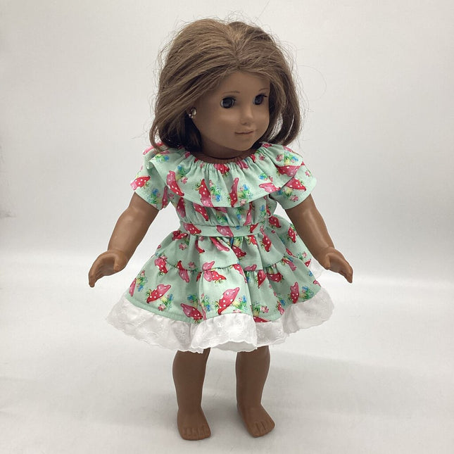 Light green dress with mushrooms all over. Ruffles around neckline and bottom skirt.