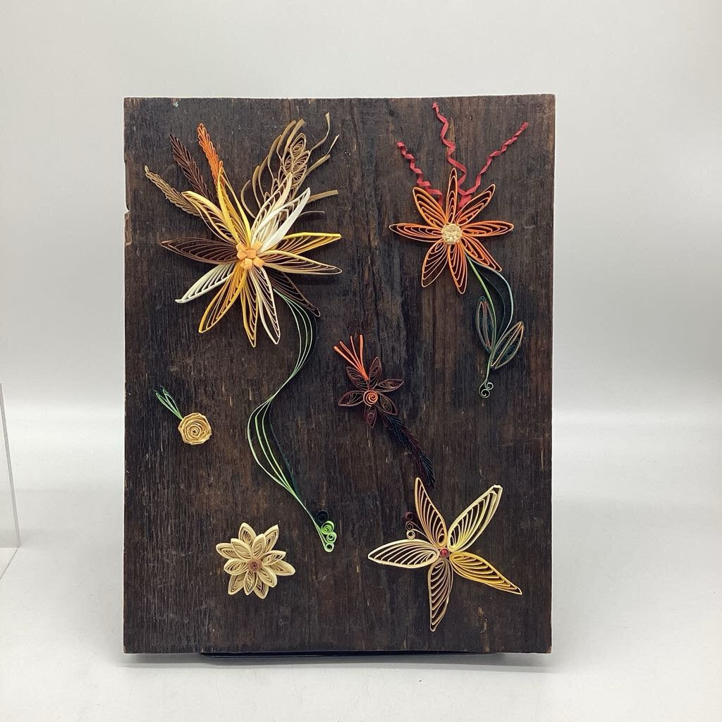 Picture on brown Barn Board with beige and orange flowers.