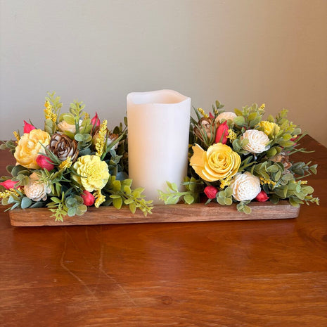 Candle surrounded by Yellow and White Sola Wood Flowers