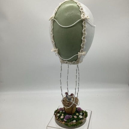 Large green and white Gourd hot air balloon with gray mouse in basket
