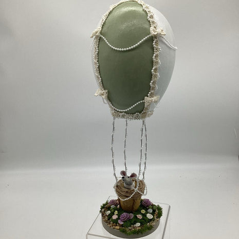 Large green and white Gourd hot air balloon with gray mouse in basket