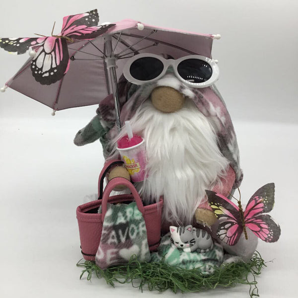 medium lavender pink umbrella white and gray cat sitting in the grass